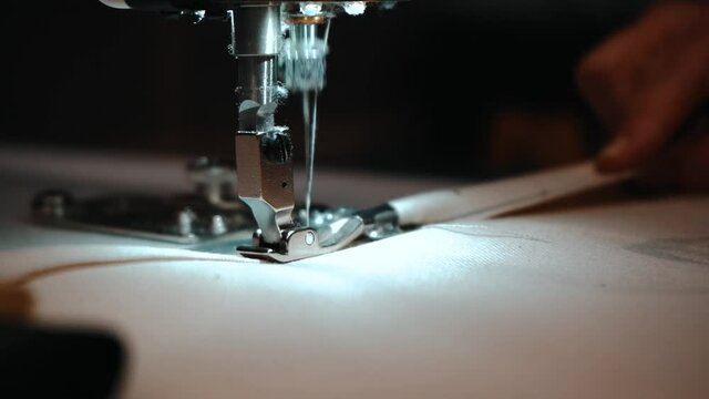 Slow motion worker using sewing machine