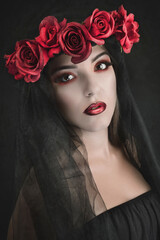 Naklejka premium portrait woman with red flowers and black veil