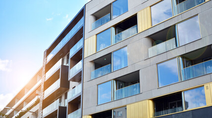 Modern apartment buildings on a sunny day with a blue sky. Facade of a modern apartment building. Glass surface with sunlight.