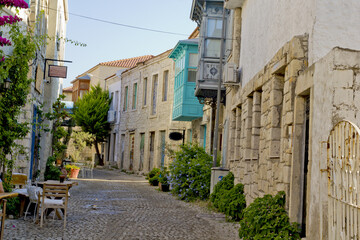 colorful and stone houses in narrow street in Alacati cesme, izmir