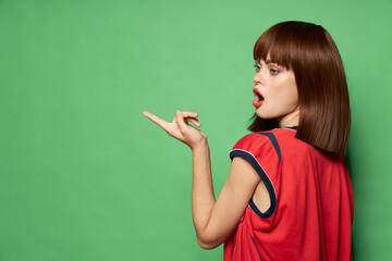emotional woman with open mouth looks away and gestures with hands free place