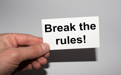 Message on the card Break the rules, in hands of businessman.