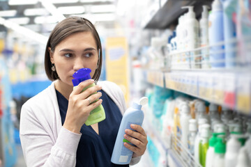 Young woman customer choosing sunscreen lotion at the pharmacy store