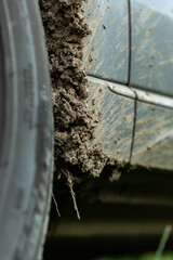 Off-road dirty car. Detail of a car with adhering dirt.