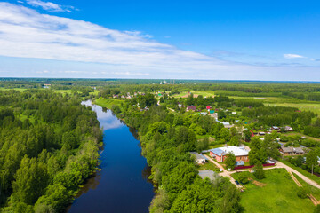 Fototapeta na wymiar The village of Krasnoarmeyskoye, Shuisky district, Ivanovo region on the Teza river on a summer day.