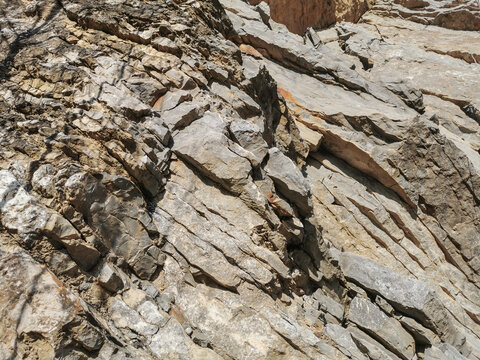 Mountain mineral rock shale with a parallel layered arrangement of yellow and gray minerals in their natural form.Landscape design. Finishing work. Geology. Construction.Minerals
