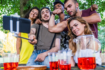 multiethnic group of millennial friends take a selfie outdoors