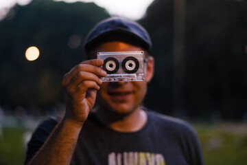 Funny portrait of a young man with an audio cassette 