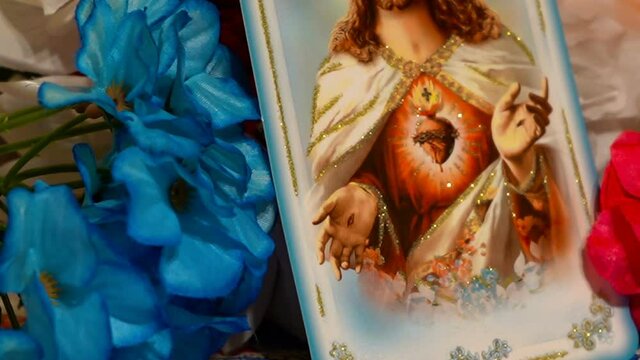 icon of Jesus Christ in flowers,catholic faith in jesus christ in flowers decorated with outstretched arms