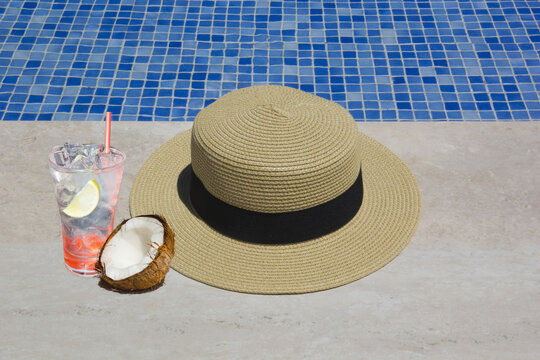 Hat and coconat on the pool in summer