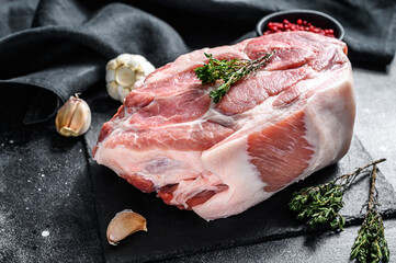 Raw pork neck meat. Chop steak. Black background. Top view