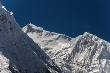 Manaslu summit rises above the far south end of Syancha glacier valley, as seen from Samdo village to Larkya Phedi camp on Manaslu Circuit trek, Manaslu Himal range, Gorkha district, Nepal Himalayas.