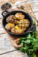Rustic oven baked potatoes with rosemary. Organic vegetables. White background. Top view