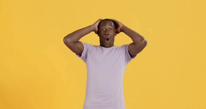 Surprised african american guy touching head in amazement