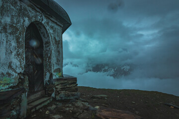 ruins of the mausoleum on the top of the mountain alps Austria just before heavy reain 