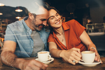 Happy couple sitting together at a coffee shop