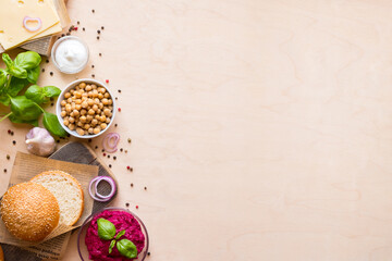 Fototapeta na wymiar Top view ingredients for cooking vegan burgers on light wooden background with copy space flat lay