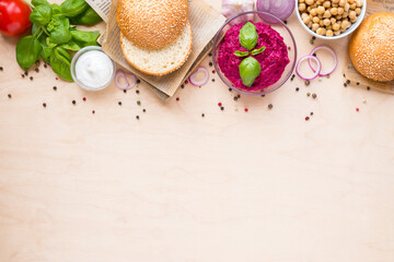 Top view ingredients for cooking vegan burgers on light wooden background with copy space flat lay