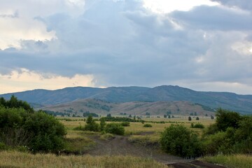 Fototapeta na wymiar Summer landscape at sunset. Beautiful panoramic view on the mountains of fields and forests