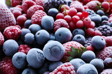 Mix of different frozen tasty berries as background, closeup