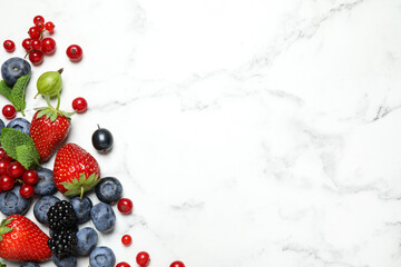 Mix of fresh berries on white marble table, flat lay. Space for text © New Africa