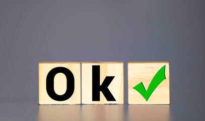 Word ok made of wooden cubes on a white background