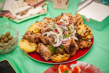 Grilled meat and vegetables on a plate close-up.