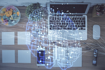 Double exposure of brain drawing hologram over topview work table background with computer. Concept of big data.