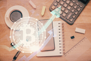 Double exposure of blockchain theme hologram over table with phone. Top view. Crypto technology concept.