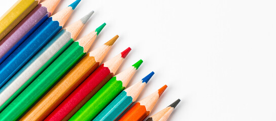 Color wooden pencils isolated on white background. Multi-colored palette for drawing, place for text.