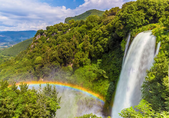 A long exposure view showing crescent-shaped rainbow produced by the spray from upper waterfalls at...