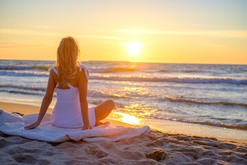 Calm woman on beach during sundown