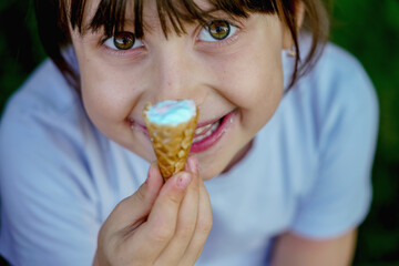 Naklejka premium Top view of beautiful young child girl eating ice cream. Selective focus.