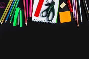 Set of stationery on black background. Back to school concept. Place for text.