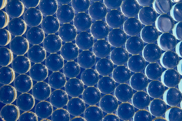 Macro of blue gel balls. Abstract bright cool geometric hydrogel background