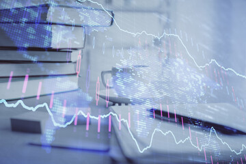 Double exposure of financial chart drawing and desktop with coffee and items on table background. Concept of forex market trading