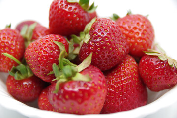 Strawberries in a bowl isolated on a white background. Red strawberries on a white background