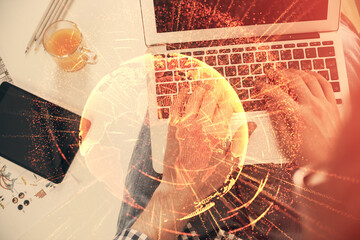 Double exposure of man's hands typing over computer keyboard and social network theme hologram drawing. Top view. People connection web concept.