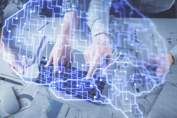 Double exposure of man and woman working together and human brain hologram drawing. Brainstorm concept. Computer background. Top View.