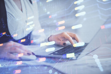 Multi exposure of woman hands working on computer and data theme hologram drawing. Tech concept.