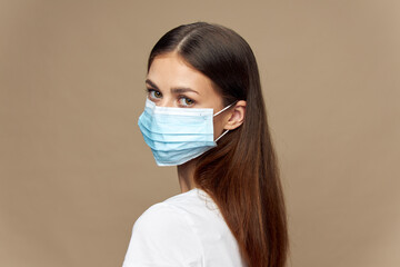 Attractive woman stylish clothes in a face mask allergy 