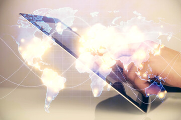 Double exposure of man's hands holding and using a phone and international business theme drawing.