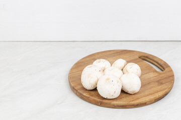 Mushrooms on the wooden cutting board with copy space