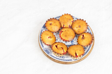Cherry Cup Cakes served on the plate above white background