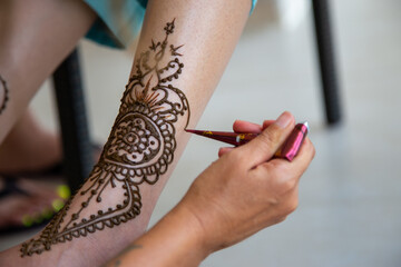 Beautiful Sikh model having henna designed and placed upon her body