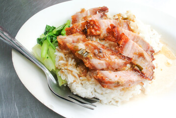 Crispy pork with rice on white dish