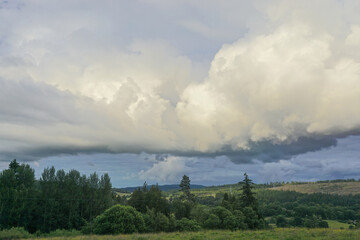 Storm clouds gather over lush farmland in the Highlands of Scotland. © Linda Harms