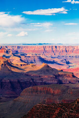 Fototapeta na wymiar Panoramic image of the colorful Sunset on the Grand Canyon in Grand Canyon National Park from the south rim part,Arizona,USA, on a sunny cloudy day with blue or gloden sky