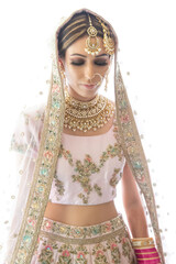 Beautiful female model wearing traditional Sikh wedding attire as she prepares for the ceremony