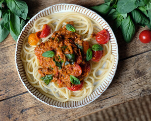 Delicious classic Bolognese spaghetti served with freah basil